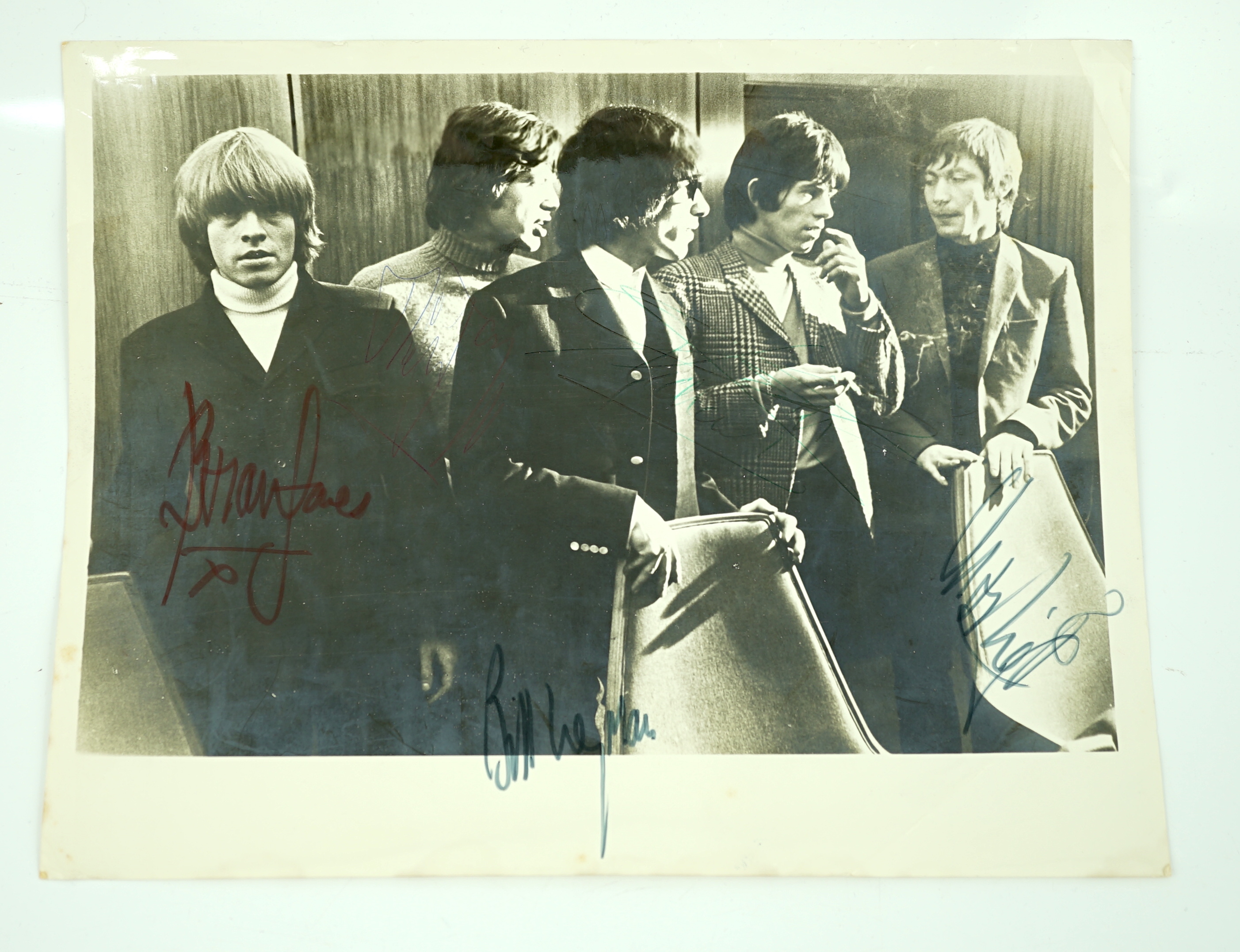 The Rolling Stones; a signed 1960s photograph including; Mick Jagger, Bill Wyman, Brian Jones, Keith Richards and Charlie Watts